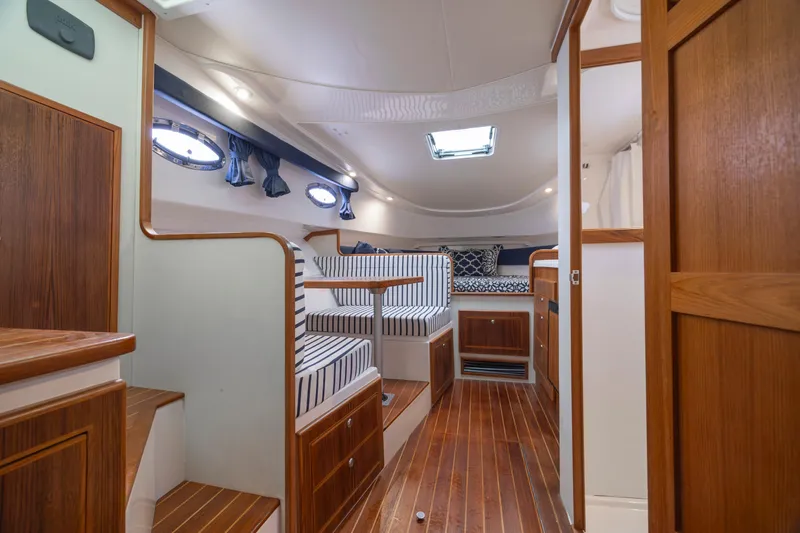 Slide: The Image of 2017 Stamas 370 Aegean interior with wood finish and striped seating. - 29