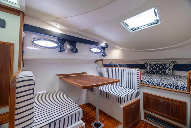 Slide: The Image of 2017 Stamas 370 Aegean cabin interior with striped seating and wooden table. - 30