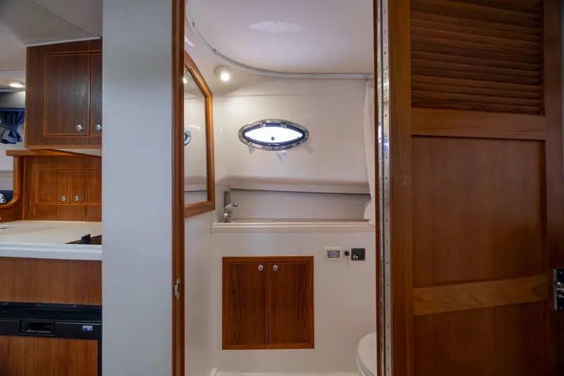 Slide: The Image of 2017 Stamas 370 Aegean yacht interior with wooden cabinetry and porthole window. - 33