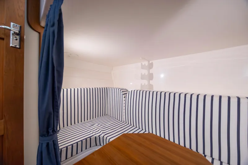 Slide: The Image of 2017 Stamas 370 Aegean cabin with striped seating and wooden table. - 38