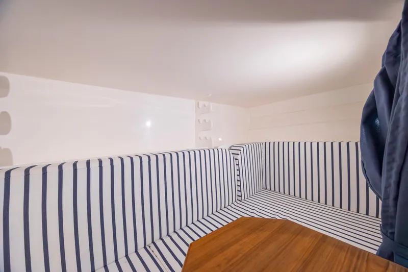 Slide: The Image of Interior of 2017 Stamas 370 Aegean boat with striped seating and wooden table. - 39