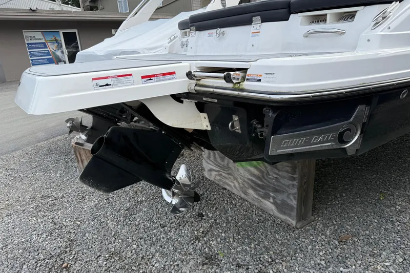 Slide: The Image of 2024 Chaparral 23 Surf boat rear view with propeller and surf gate. - 10