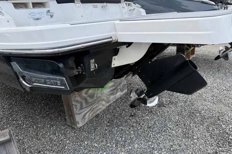 Slide: The Image of 2024 Chaparral 23 Surf boat rear view with Surf Gate and propeller details. - 11