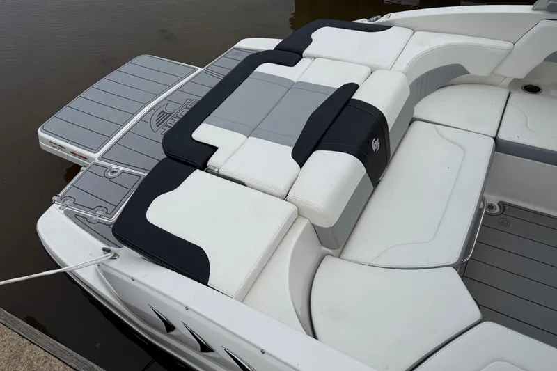 Slide: The Image of 2024 Chaparral 23 Surf boat with sleek seating and swim platform design. - 5