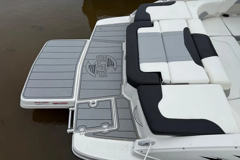 Slide: The Image of 2024 Chaparral 23 Surf boat with sleek seating and swim platform design. - 6