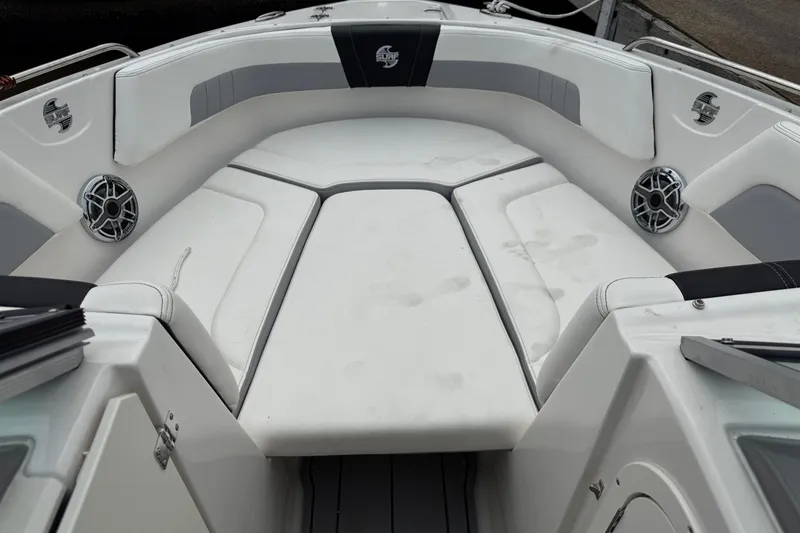 Slide: The Image of 2024 Chaparral 23 Surf boat interior with cushioned seating and speakers. - 8
