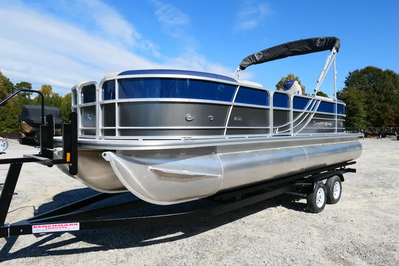 Slide: The Image of 2022 South Bay 224 RS pontoon boat on trailer, parked outdoors. - 11