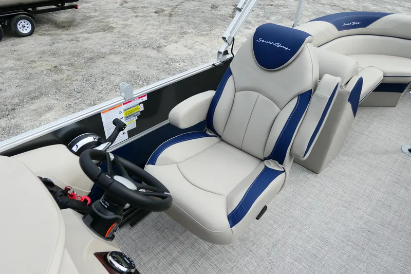 Slide: The Image of 2022 South Bay 224 RS boat interior with plush seating and steering wheel. - 5
