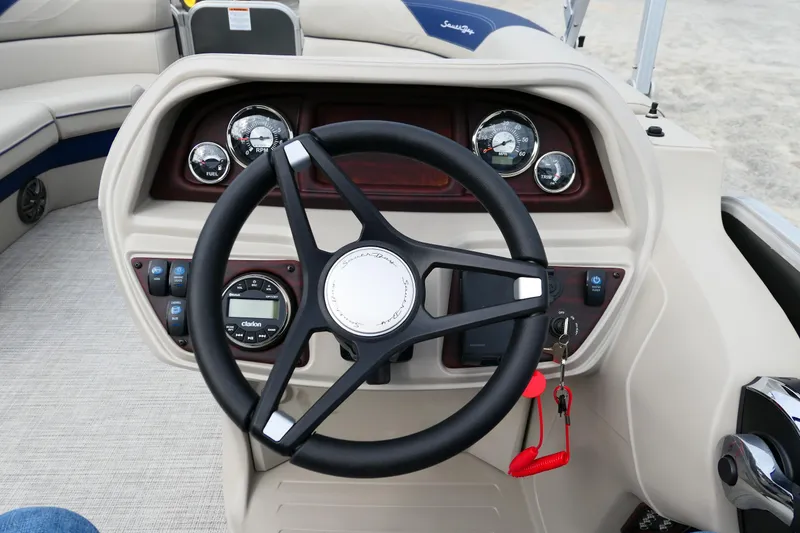 Slide: The Image of Steering wheel and dashboard of 2022 South Bay 224 RS boat, featuring gauges and controls. - 6