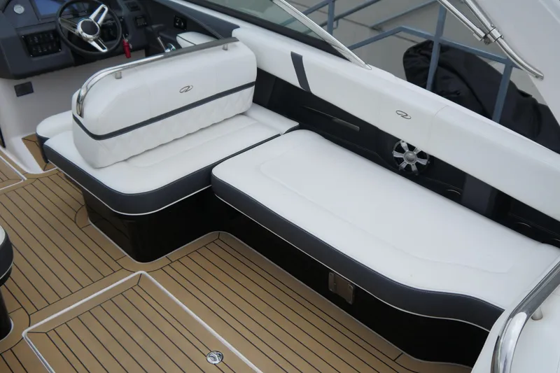 Slide: The Image of 2018 Regal 2800 Bowrider interior with white seating and teak flooring. - 10