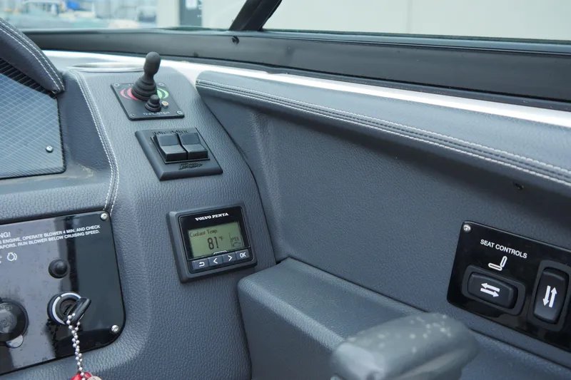 Slide: The Image of Control panel of 2018 Regal 2800 Bowrider boat with seat controls and temperature display. - 15