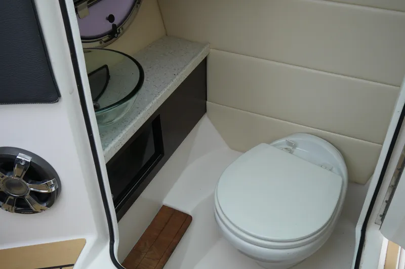 Slide: The Image of 2018 Regal 2800 Bowrider boat bathroom with modern toilet and glass sink. - 18