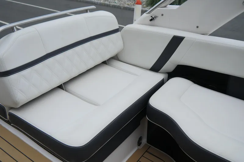 Slide: The Image of 2018 Regal 2800 Bowrider interior seating with white upholstery and black accents. - 21