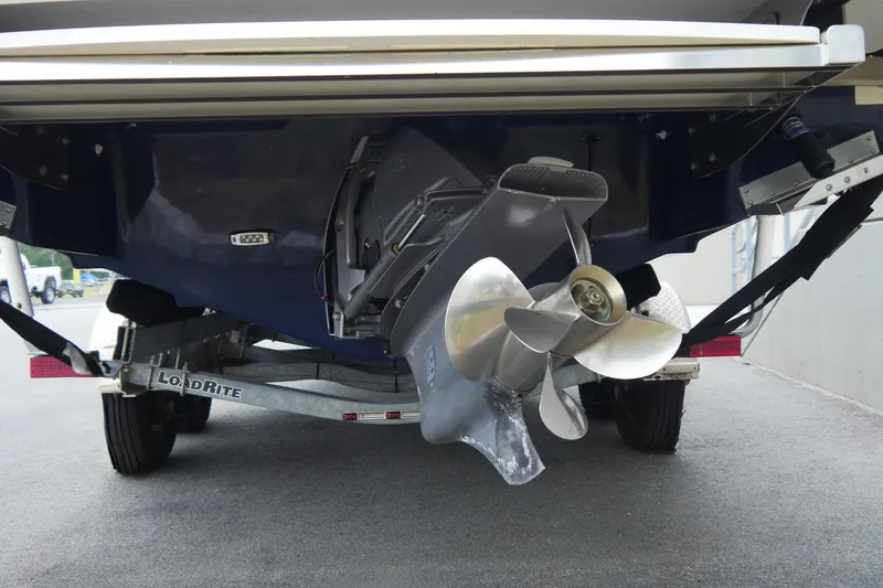Slide: The Image of 2018 Regal 2800 Bowrider boat on trailer, showcasing propeller and stern details. - 5