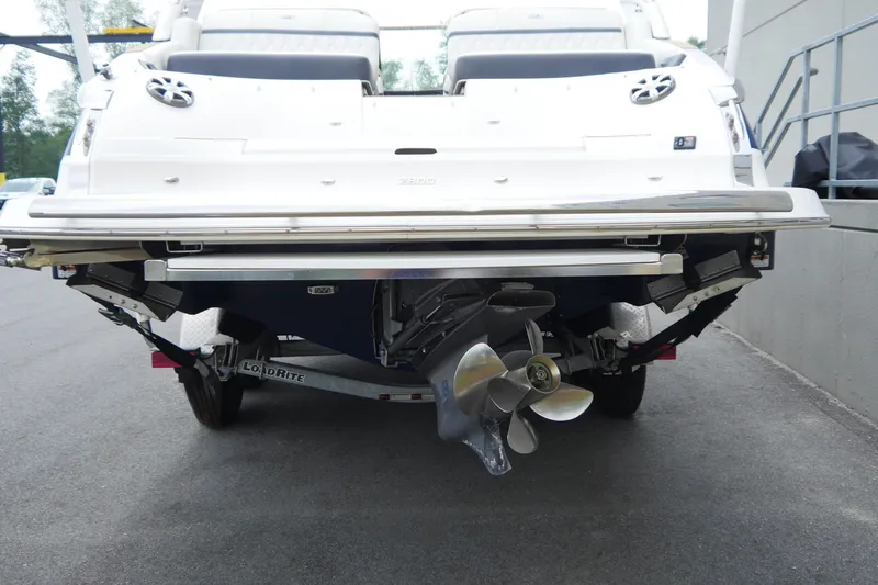Slide: The Image of 2018 Regal 2800 Bowrider boat rear view with propeller and trailer. - 6