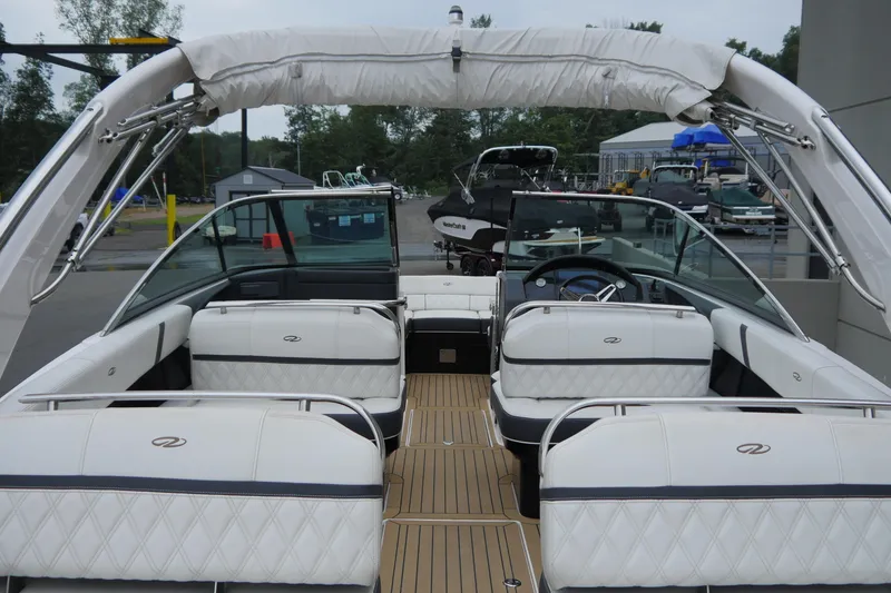 Slide: The Image of 2018 Regal 2800 Bowrider boat with luxurious white seating and sleek design. - 8