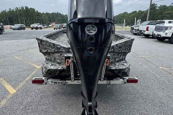 Slide: The Image of 2024 Havoc 1756 MRST boat with camouflage design on a trailer in a parking lot. - 11