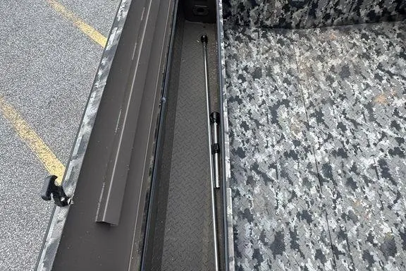 Slide: The Image of 2024 Havoc 1756 MRST boat interior with camo flooring and storage compartment. - 14