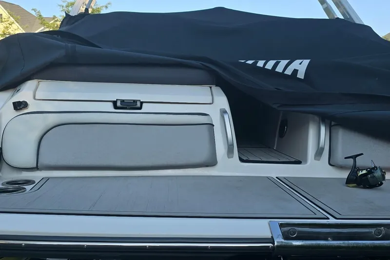 Slide: The Image of 2022 Yamaha Boats 275 SD rear deck with cover partially removed. - 17