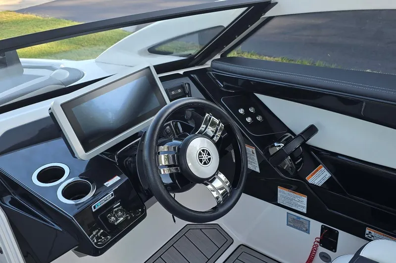 Slide: The Image of 2022 Yamaha Boats 275 SD dashboard with steering wheel and touchscreen display. - 21