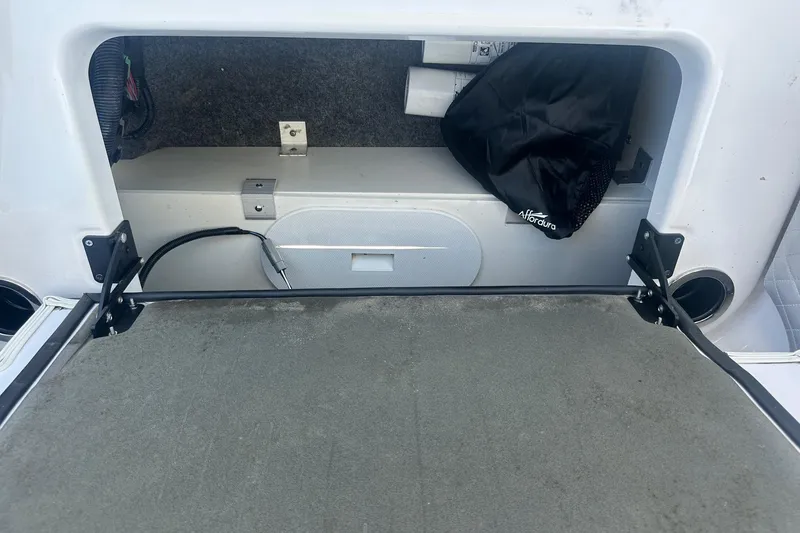 Slide: The Image of 2022 Yamaha Boats 275SD storage compartment with Affordura bag and wiring. - 37