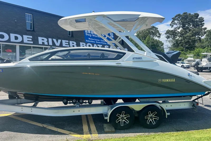 Slide: The Image of 2022 Yamaha Boats 275SD on trailer at dealership, sunny day. - 4