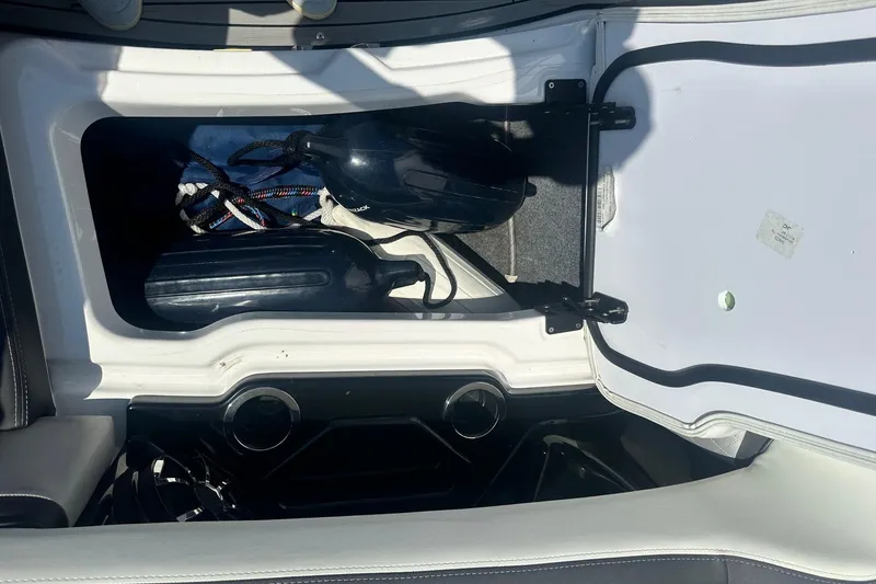 Slide: The Image of Open storage compartment in 2022 Yamaha Boats 275SD, showing ropes and equipment. - 41