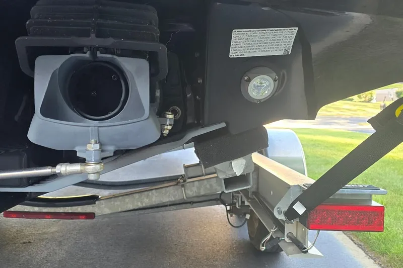 Slide: The Image of Close-up of 2022 Yamaha Boats 275 SD engine and trailer components. - 6