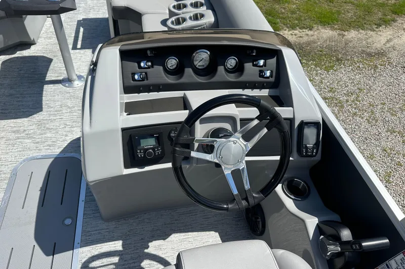 Slide: The Image of 2025 Bennington 22L boat dashboard with steering wheel, gauges, and controls. - 4