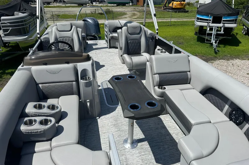 Slide: The Image of 2025 Bennington 22L pontoon boat interior with luxurious seating and cup holders. - 5