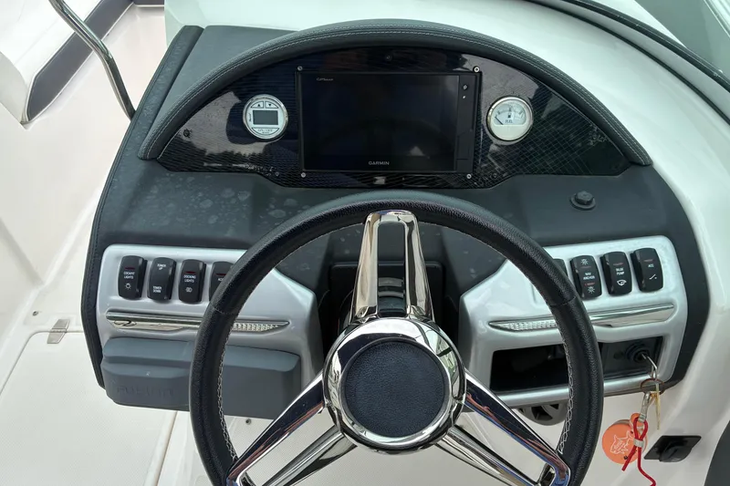 Slide: The Image of 2020 Regal 23 OBX boat dashboard with steering wheel and control panel. - 10