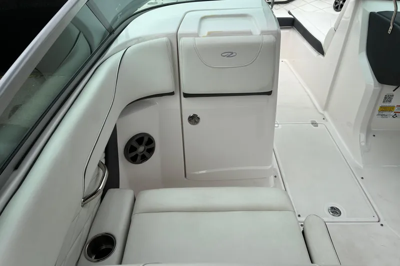 Slide: The Image of 2020 Regal 23 OBX boat interior with white seating and storage compartment. - 11