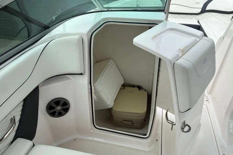 Slide: The Image of 2020 Regal 23 OBX boat interior with storage compartment and portable toilet. - 12