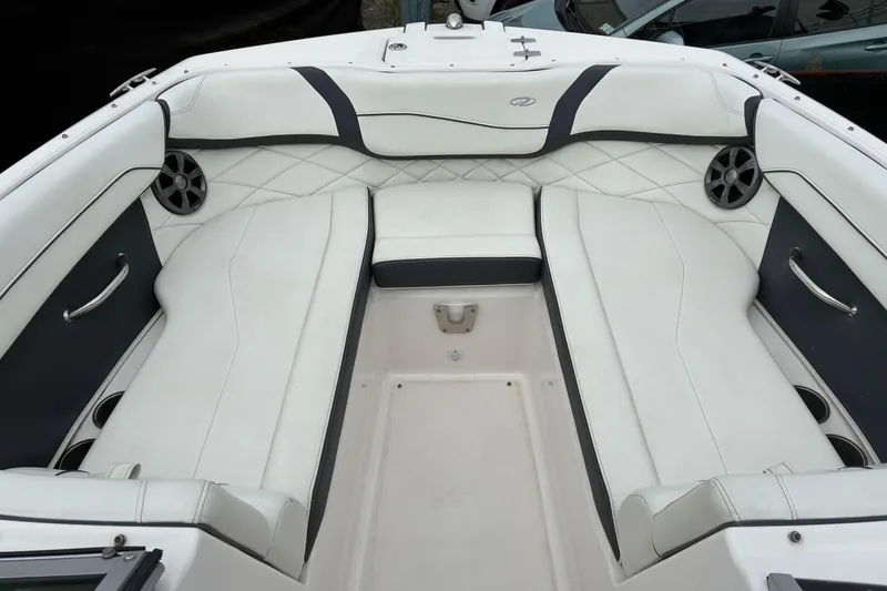 Slide: The Image of 2020 Regal 23 OBX boat interior with white cushioned seating and speakers. - 14