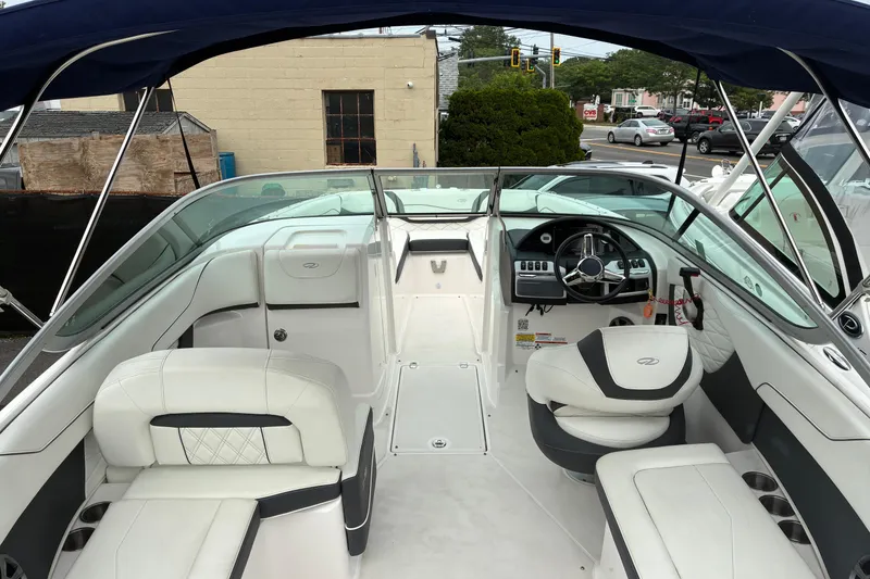 Slide: The Image of 2020 Regal 23 OBX boat interior with white seating and steering wheel. - 5