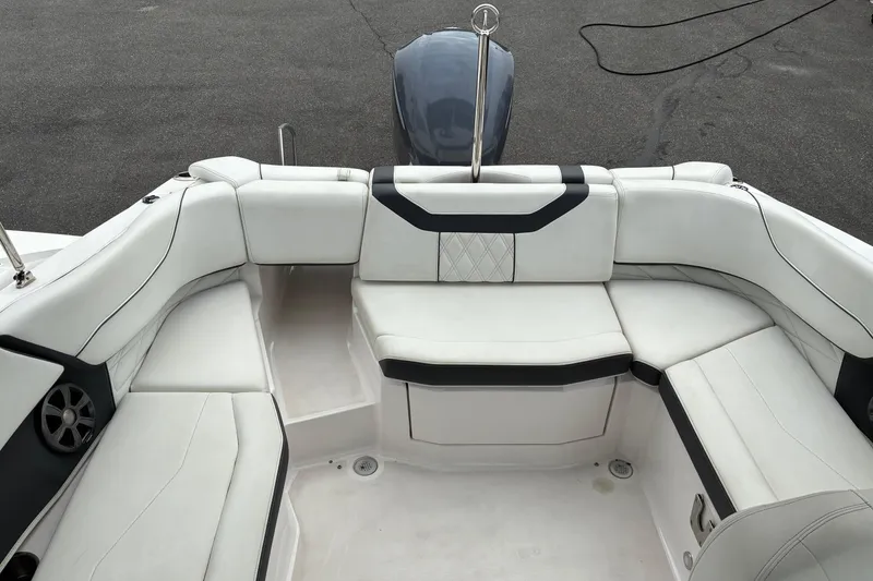Slide: The Image of 2020 Regal 23 OBX boat interior with white cushioned seating and sleek design. - 7