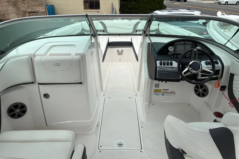 Slide: The Image of 2020 Regal 23 OBX boat interior with steering wheel and seating area. - 8