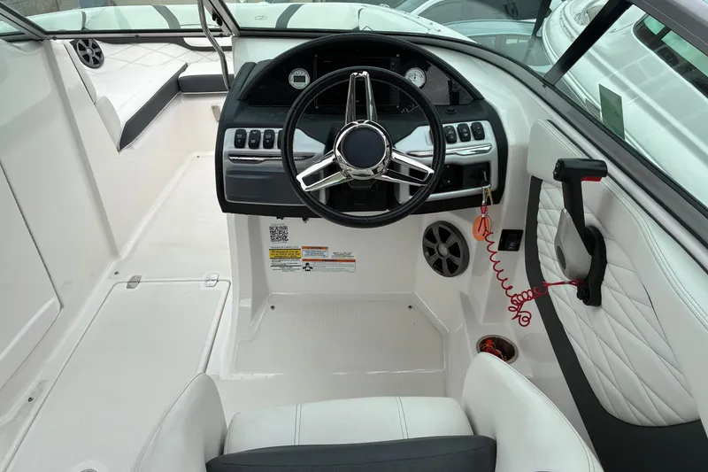 Slide: The Image of 2020 Regal 23 OBX boat cockpit with steering wheel and control panel. - 9