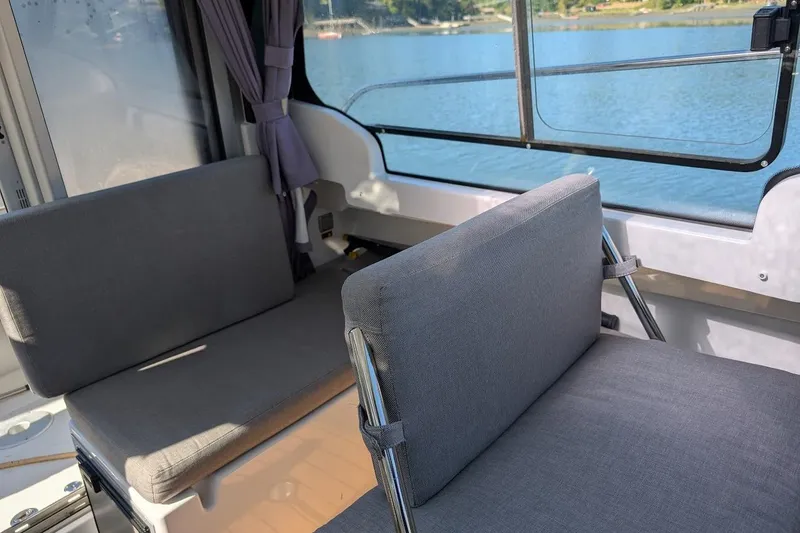Slide: The Image of Interior seating of 2020 Jeanneau NC 695 Series 2 boat with lake view. - 16
