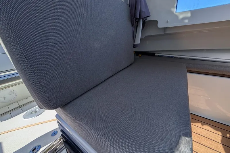 Slide: The Image of 2020 Jeanneau NC 695 Series 2 boat interior with gray cushioned seating. - 17