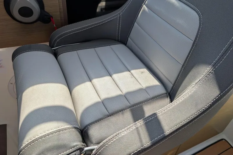 Slide: The Image of Gray cushioned seat on 2020 Jeanneau NC 695 Series 2 boat, showcasing detailed stitching. - 18