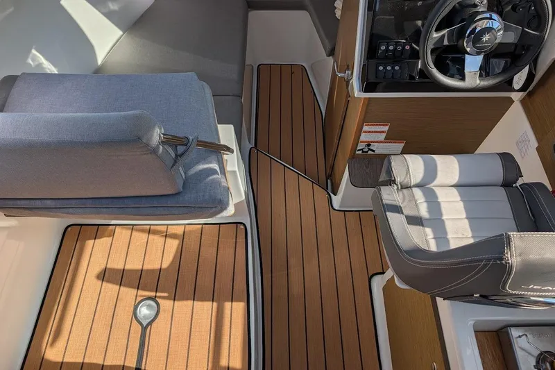 Slide: The Image of Interior of 2020 Jeanneau NC 695 Series 2 boat with seating and steering wheel. - 19