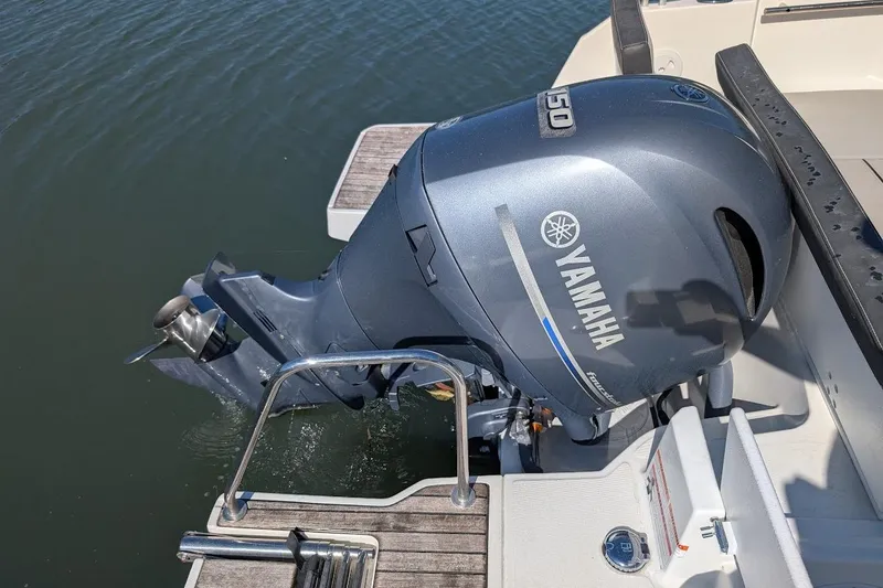 Slide: The Image of Yamaha outboard motor on 2020 Jeanneau NC 695 Series 2 boat, docked on water. - 24