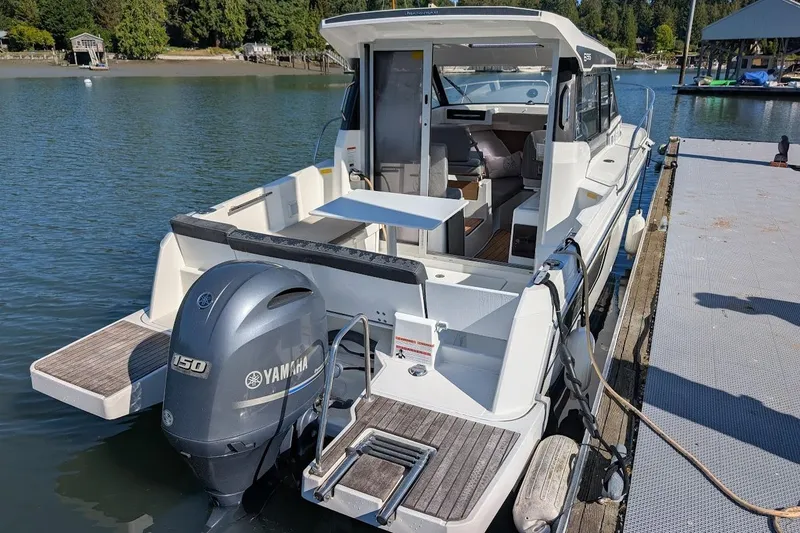 Slide: The Image of 2020 Jeanneau NC 695 Series 2 boat docked with Yamaha 150 engine. - 4