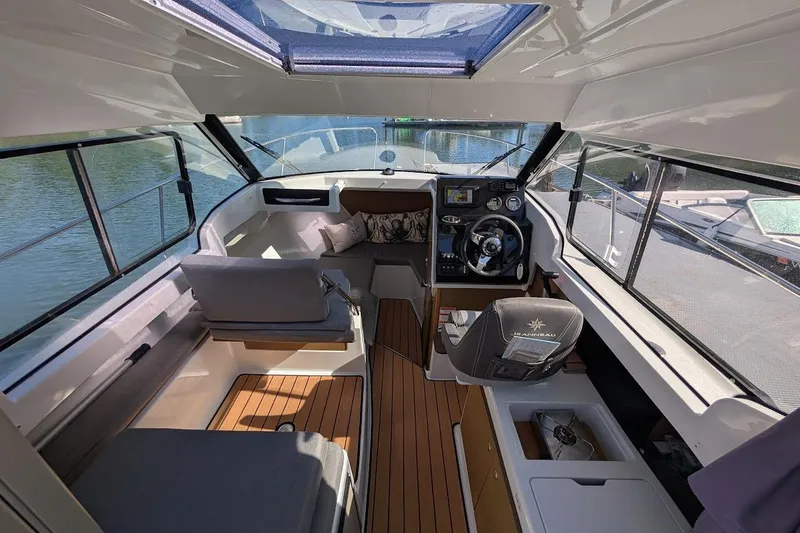 Slide: The Image of Interior of 2020 Jeanneau NC 695 Series 2 boat with modern helm and seating. - 7