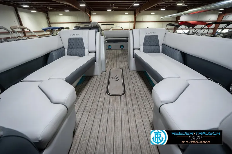 Slide: The Image of 2020 Harris Solstice pontoon boat with spacious seating, displayed indoors at Reeder-Trausch Marine. - 14