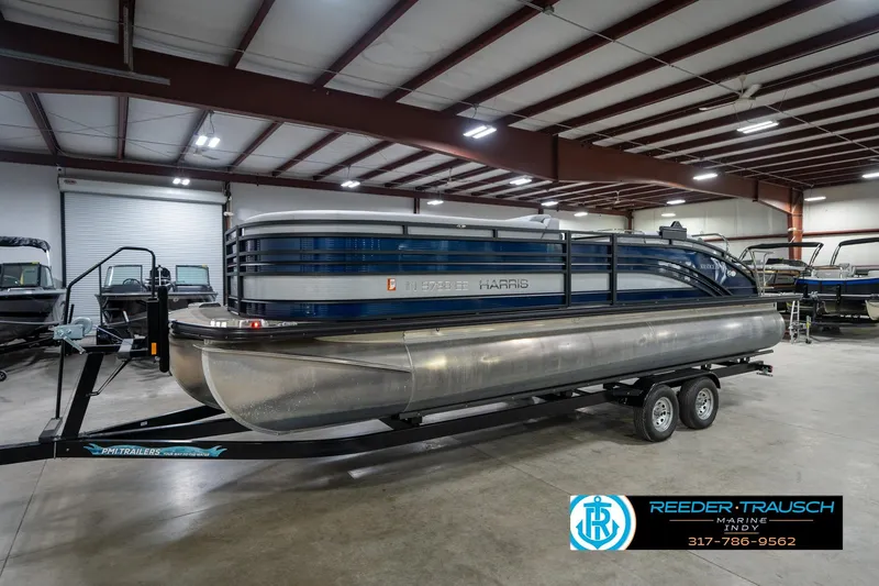 The Image of 2020 Harris Solstice pontoon boat in showroom, side view, on trailer. - 2