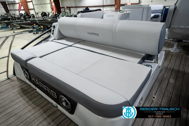 Slide: The Image of 2020 Harris Solstice boat interior with gray and white seating, cup holder, and logo. - 23