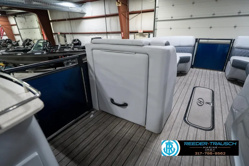 Slide: The Image of 2020 Harris Solstice boat interior with gray seating, cup holders, and Reeder-Trausch Marine logo. - 25