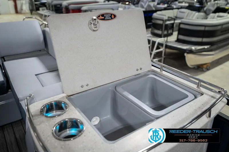 Slide: The Image of 2020 Harris Solstice boat interior with cup holders and storage compartment. - 28